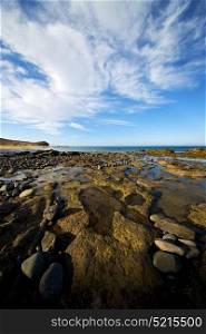 in lanzarote spain rock stone sky cloud beach water musk pond coastline and summer