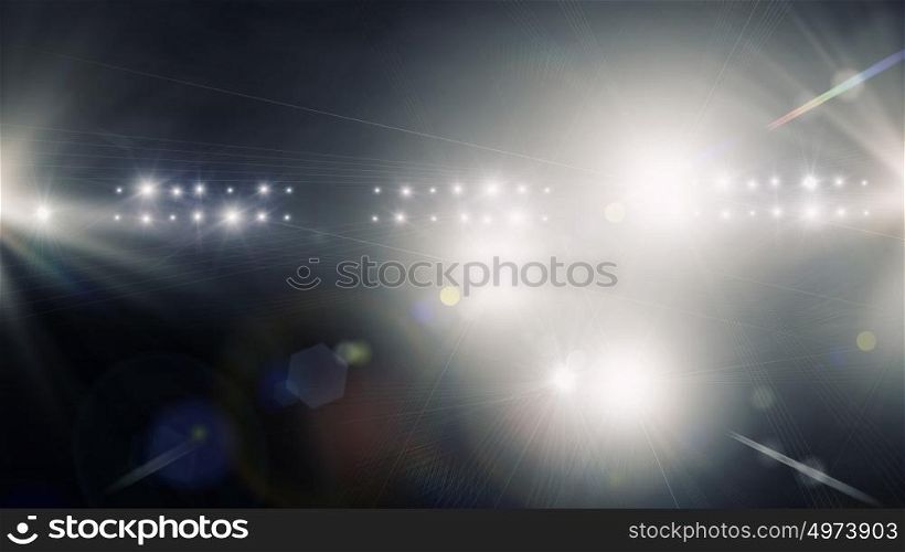In lights of stage. Background image with defocused blurred stage lights
