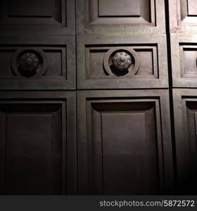 in london antique brown door rusty brass nail and light