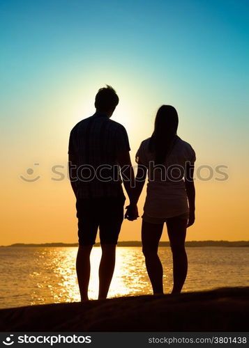 In love young couple enjoying the sunset together, beautiful evening in archipelago