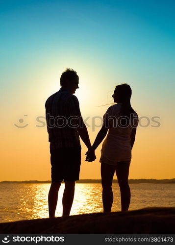 In love young couple enjoying the sunset together, beautiful evening in archipelago