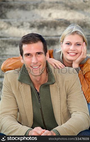 In loved couple sitting in staircase