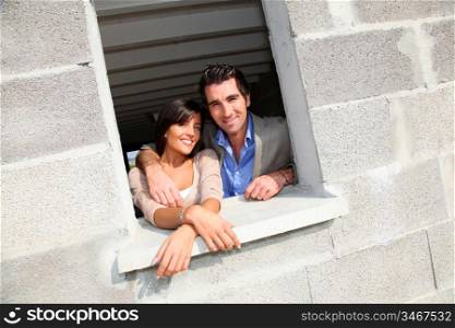In loved couple standing in their future house