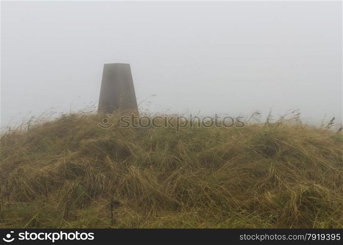 In low lying cloud, triangulation Point on Eggardon Hill, Dorset, England, United Kingdom.