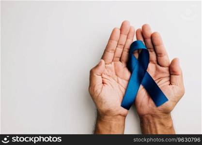 In November, a blue ribbon, symbolizing men’s health and prostate cancer awareness, is held in hands against a white background. A poignant reminder for all, especially fathers.