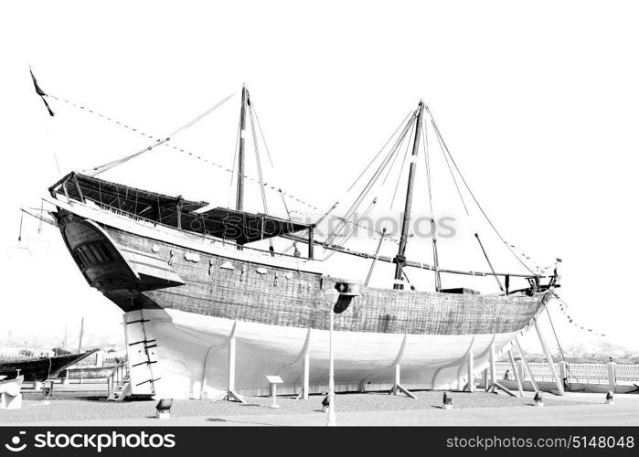 in oman old boat in the sidewalk near the sea