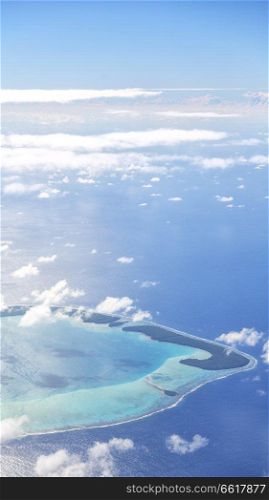 in polynesia moorea the view of the reef from the airplane cloud and ocean