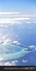 in polynesia moorea the view of the reef from the airplane cloud and ocean