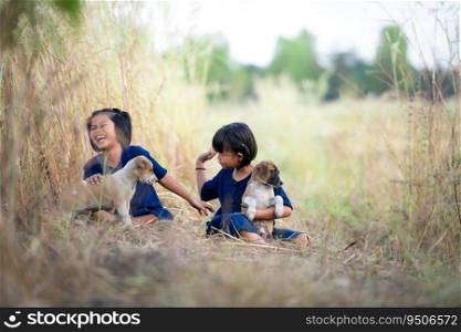 In rural Thailand, little girls play together joyfully laugh together and play with the pet dogs