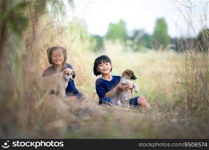 In rural Thailand, little girls play together joyfully laugh together and play with the pet dogs