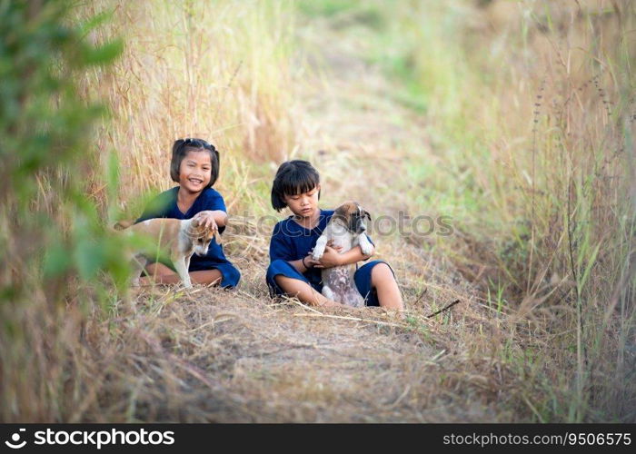 In rural Thailand, little girls play together joyfully laugh together and play with the pet dogs