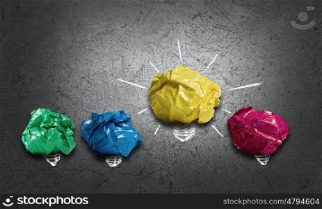 In search of creative idea. Set of colourful crumpled paper balls on grey surface