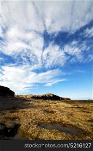 in spain lanzarote rock stone sky cloud beach water musk pond coastline and summer