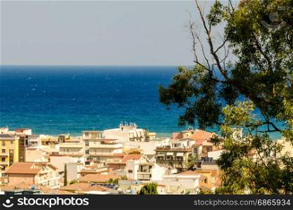 In the blue intensity of the Mediterranean Sea, overlook the houses of a Sicilian country