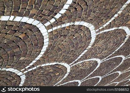 in the castano primo street lombardy italy varese abstract pavement of a curch and marble