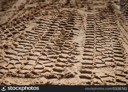 in the desert beach track of car and truck in the sand like abstract background