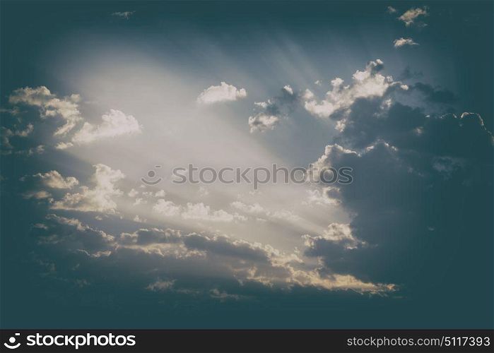 in the empty sky lots of clouds and sunny ray of light