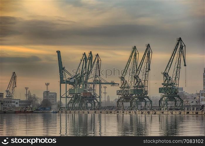 In the evening, the silhouette of port cranes.Ready to load containers from cargo ships.