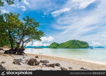 in the frame tree, beach, Andaman Sea and beautiful mountains on the horizon, Thayland, Krabi resort