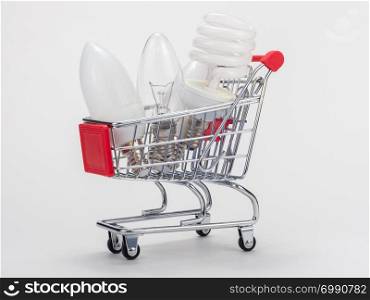 In the grocery cart are three light bulbs: incandescent, energy-saving and LED