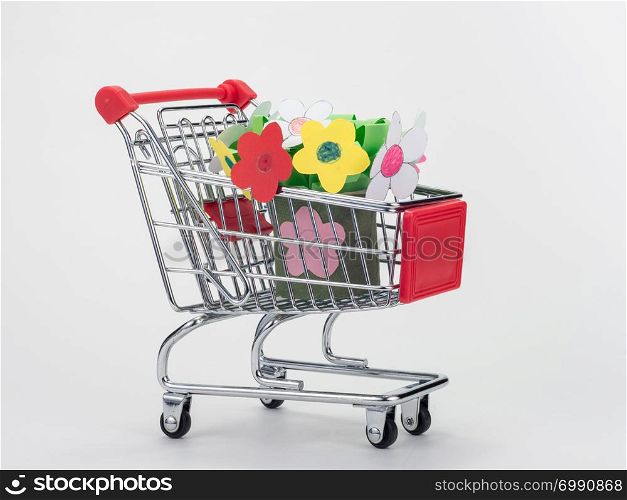 In the grocery cart of the store is a children&rsquo;s hand-made bouquet of flowers