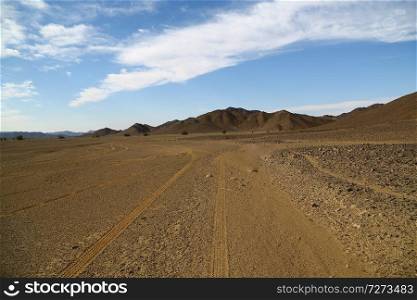 in the middle of the desert rock and track like concept of wild and nature scenic land 

