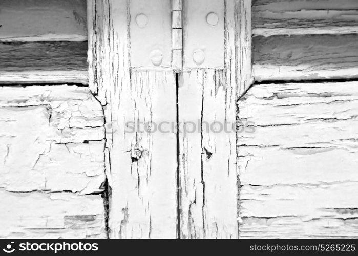 in the old wall a hinged window green wood and rusty metal