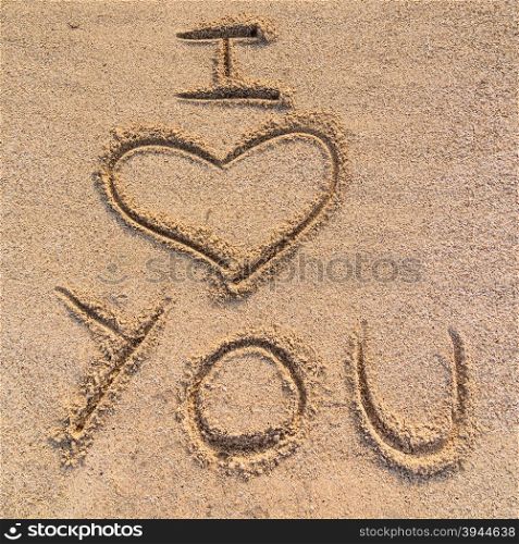 "In the picture an inscription on the sand "I love you"."