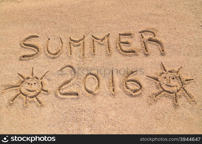 "In the picture the words on the sand "Summer 2016"."