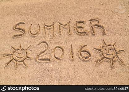 "In the picture the words on the sand "Summer 2016"."