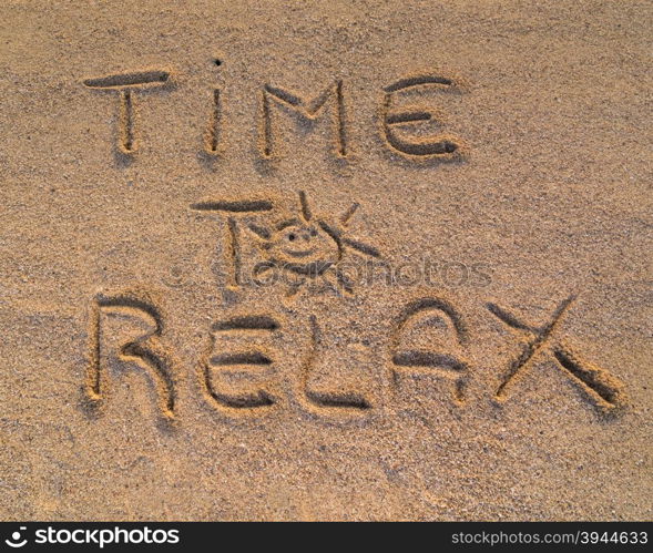 "In the picture the words on the sand "Time to relax""