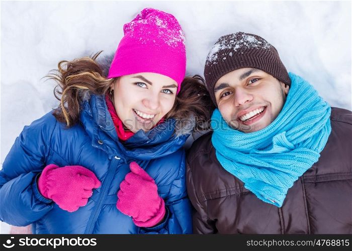 In winter park. Happy young couple in winter park having fun