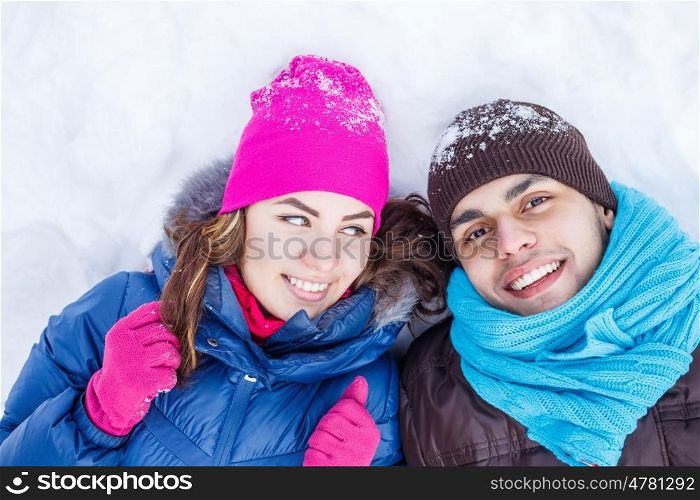 In winter park. Happy young couple in winter park having fun