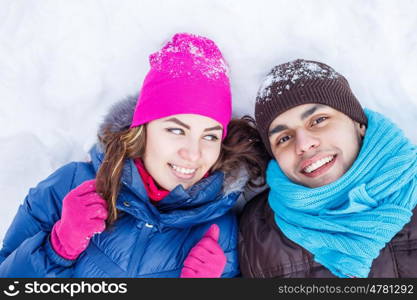 In winter park. Happy young couple in winter park having fun