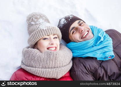 In winter park. Happy young couple in winter park having fun