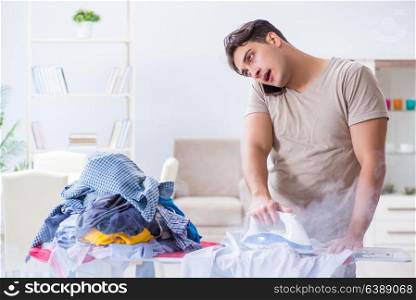 Inattentive husband burning clothing while ironing