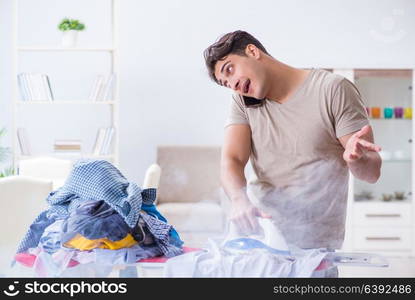 Inattentive husband burning clothing while ironing