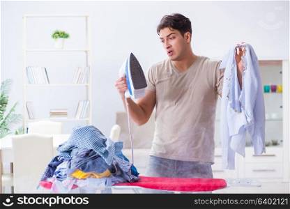 Inattentive husband burning clothing while ironing