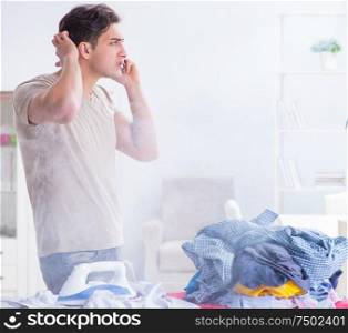 Inattentive husband burning clothing while ironing. The inattentive husband burning clothing while ironing
