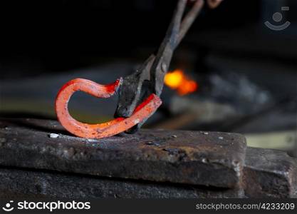 Incandescent element in the smithy on the anvil