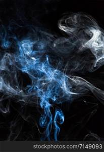 Incense smoke spread on a black background.