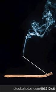 Incense Stick in a Holder, Burning with Smoke, Black Background
