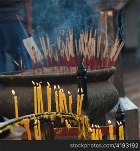 Incense sticks and candles burning at Wat Phrathat Doi Suthep, Chiang Mai, Thailand