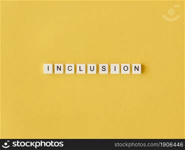 inclusion word written scrabble letters yellow background. High resolution photo. inclusion word written scrabble letters yellow background. High quality photo