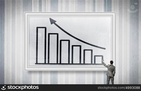 Income and growth concept. Rear view of businessman drawing growing arrow on white banner