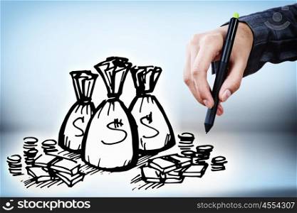 Income concept. Close up of businessman drawing money bags