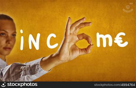 Income concept. Income word and businesswoman showing with fingers letter o