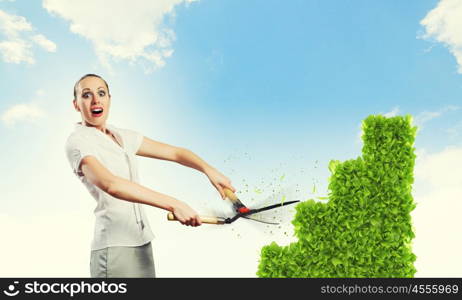 Income concept. Young attractive businesswoman cutting lawn in shape of graph