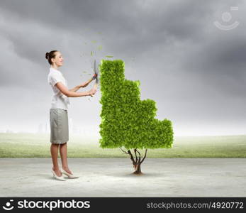 Income concept. Young attractive businesswoman cutting lawn in shape of graph