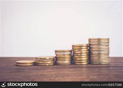 Increase coin stacks, saving money growth fund.. Raise gold coin stacks, worldwide currency on wooden table Blank background copy space, vintage style. Money concepts for saving, growth fund, increase invesment, finance, business budget planning.